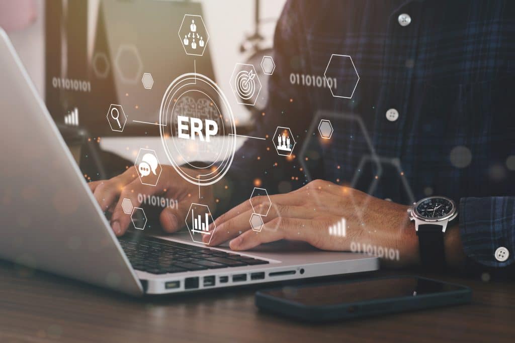 Businessman using a computer to Enterprise Resource Management ERP software system for business resources plan presented in modern graphic interface showing future technology to manage company enterprise resource.